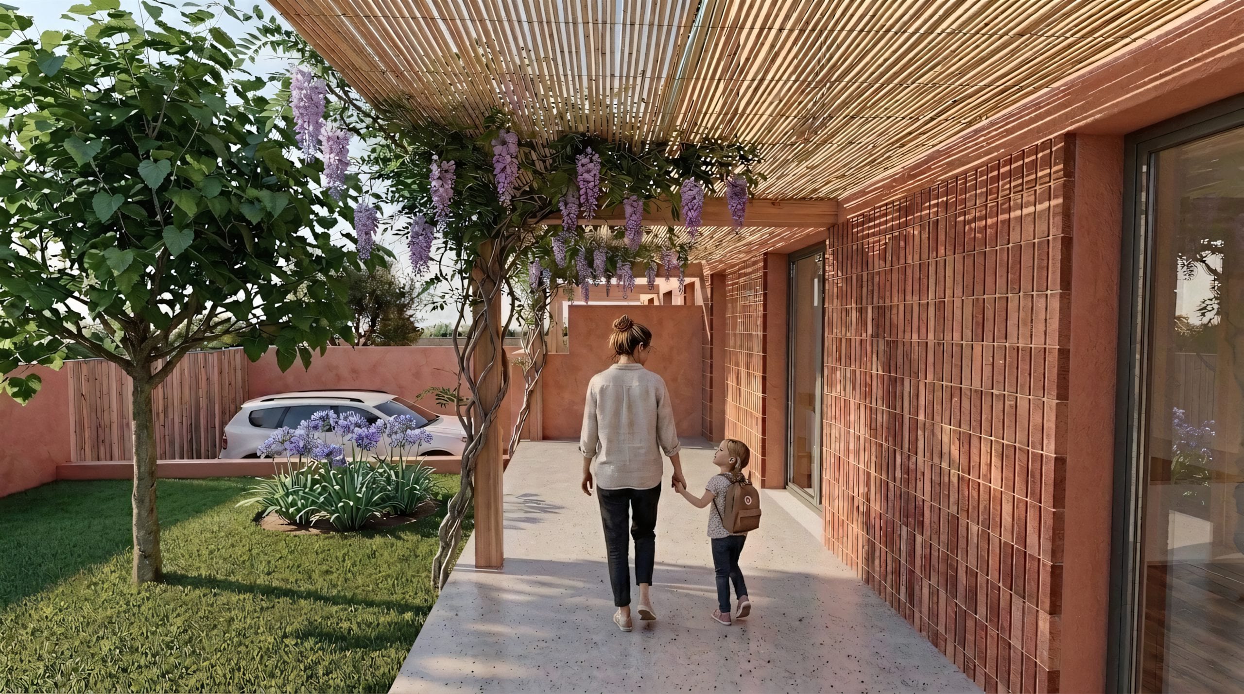 Porxo d'accés sota la pèrgola amb glicina florida: a la dreta, el mur de gresite i la corredora; a l'esquerra, el jardí amb l'arbre i la plaça d'aparcament.